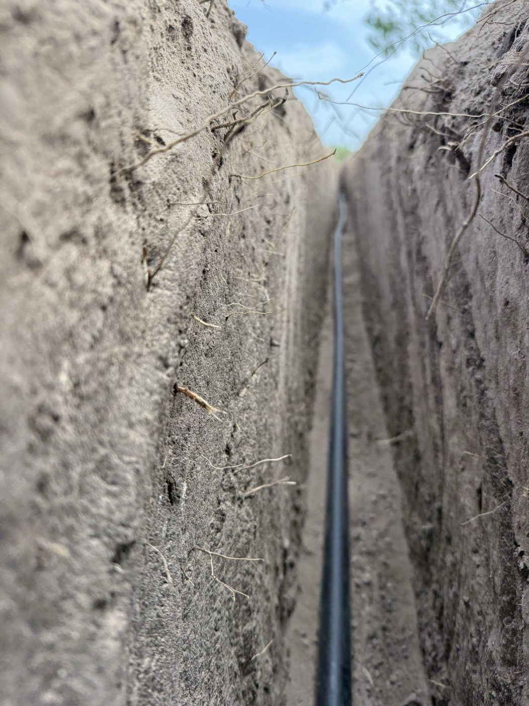 Poly water line laid in a freshly cut trench
